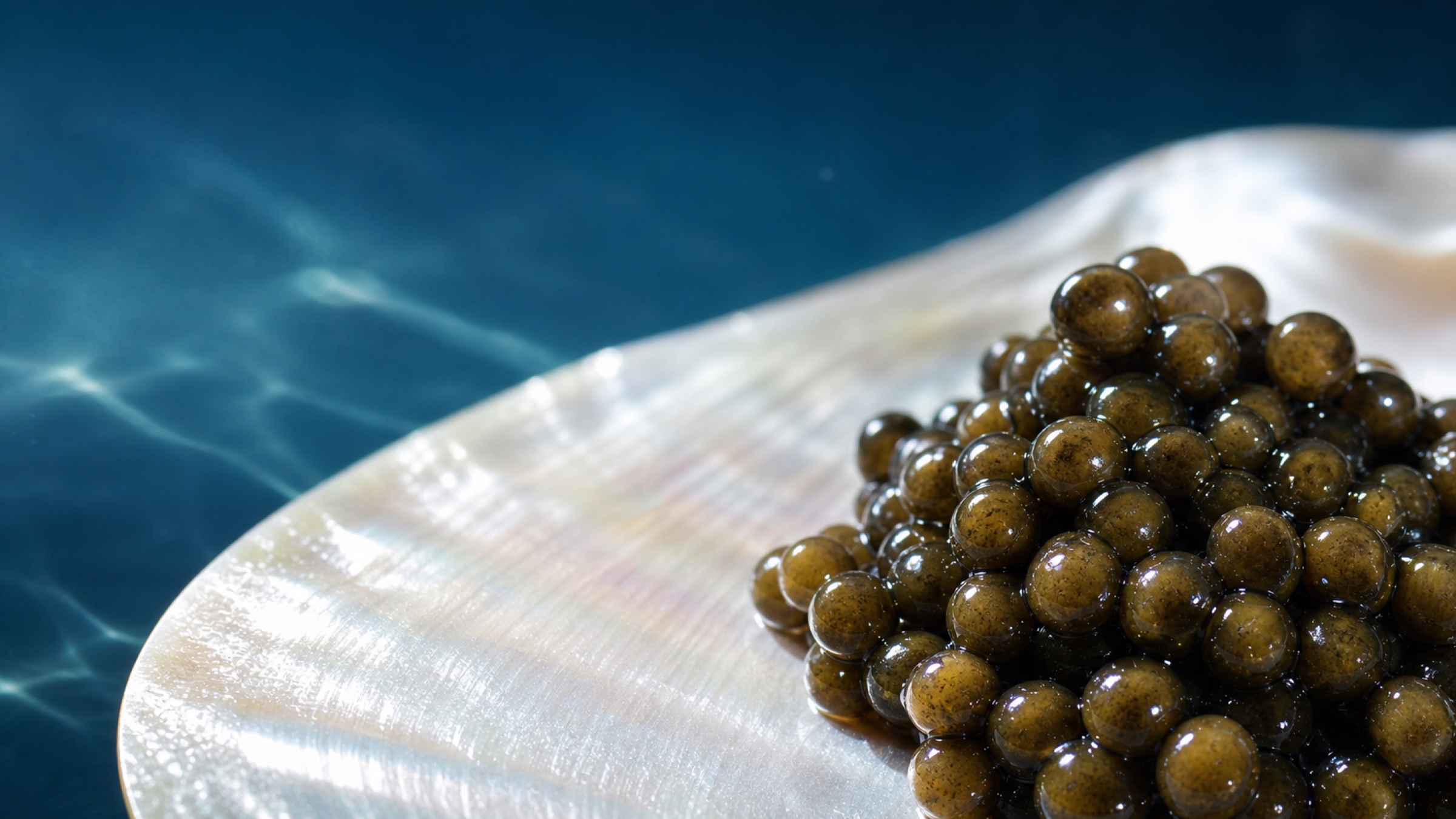 Extreme close view of caviar on iridescent mother-of-pearl