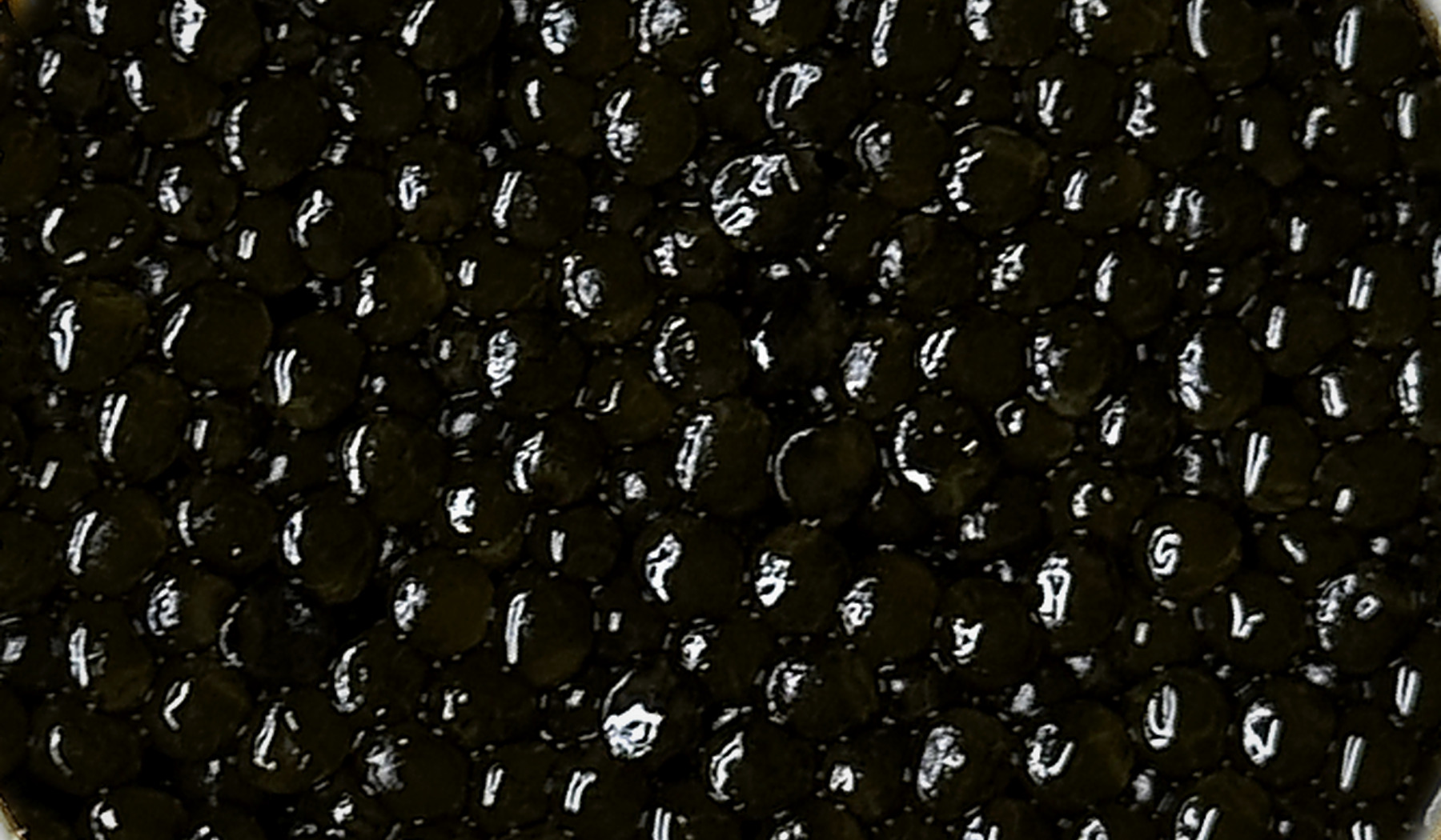 Macro view of AMANO Ossetra caviar pearls from the same editorial batch