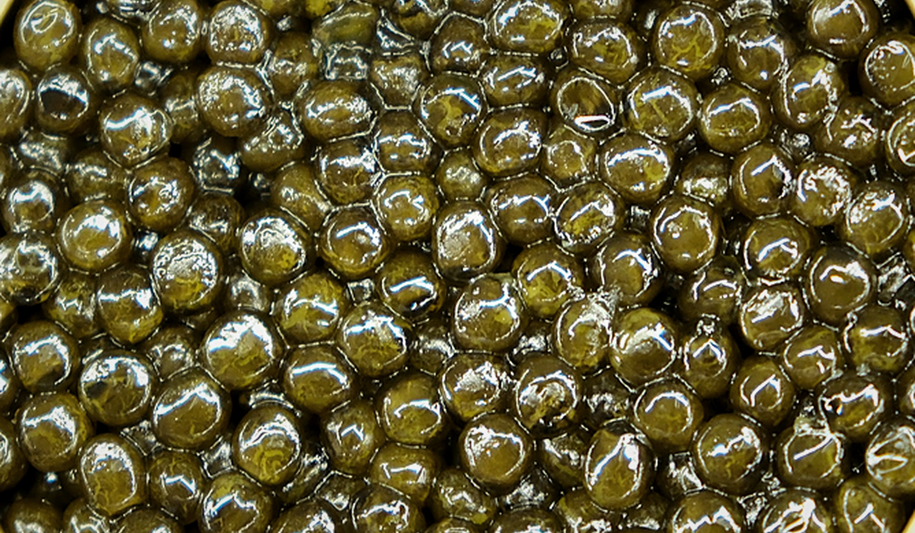 Macro view of AMANO Ossetra Hybrid caviar pearls from the same editorial batch